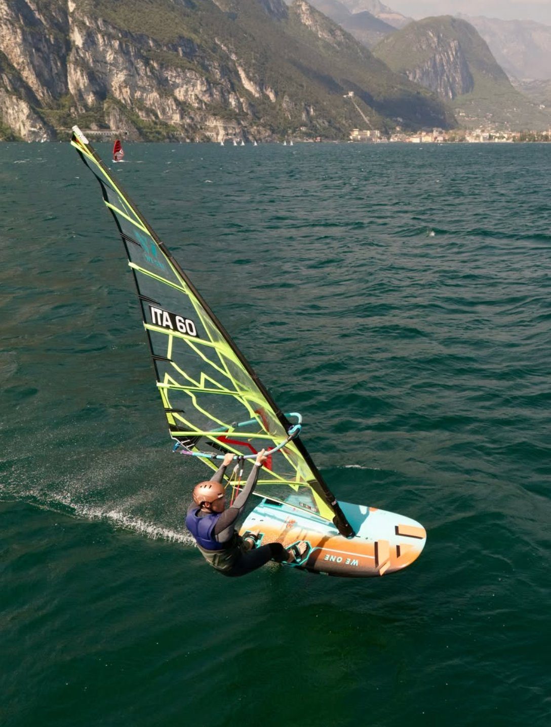 Close-up action of Daniele Benedetti ITA 60 planing on Lake Garda with CHS Wind Solutions sail
