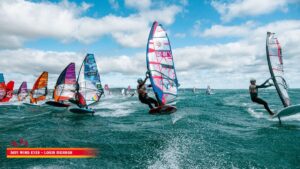 Jhon Soukos (GRE-198) flying his CHS Challenger sail on foil at the 2026 Défi Wind in Gruissan, France, surrounded by the international fleet at the start.