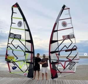 John Soukos GRE-198 and Cyril Evrard BEL-250 posing with their CHS sails on the beach at Leucate IFCA Worlds 2026