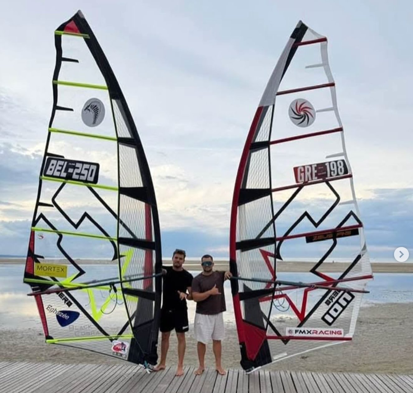 John Soukos GRE-198 and Cyril Evrard BEL-250 posing with their CHS sails on the beach at Leucate IFCA Worlds 2026
