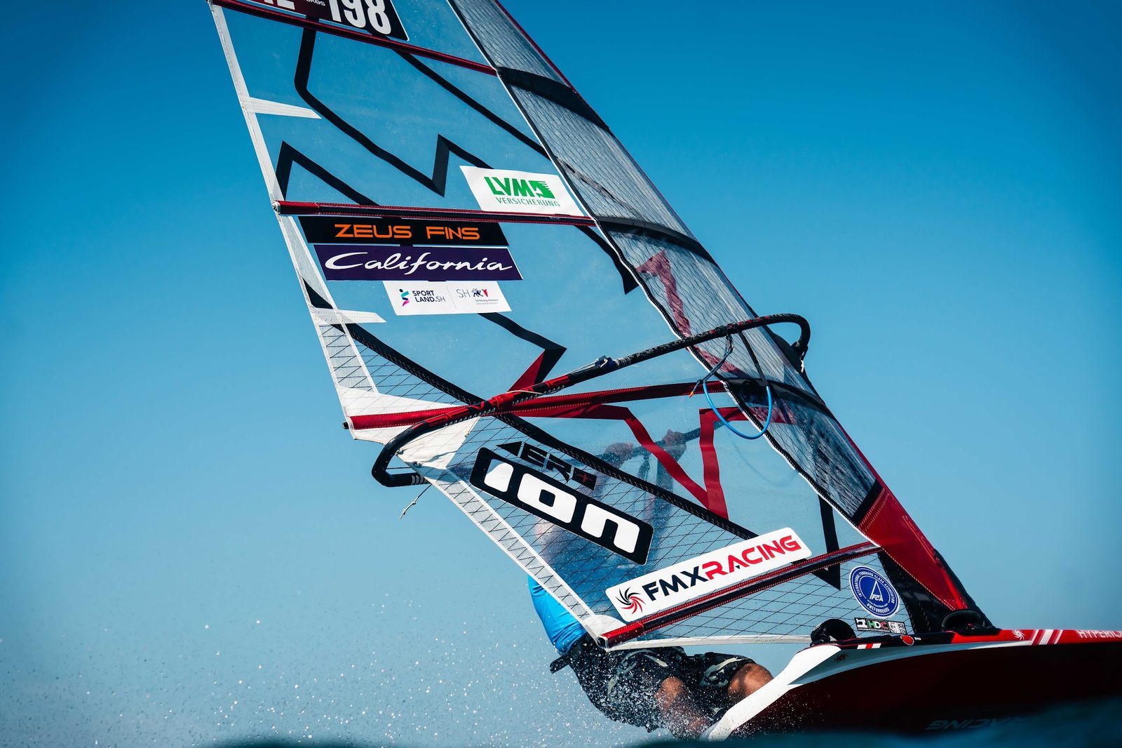 Close-up of John Soukos foiling at full speed on his CHS Challenger foil sail at the 2026 IFCA Foiling European Championships