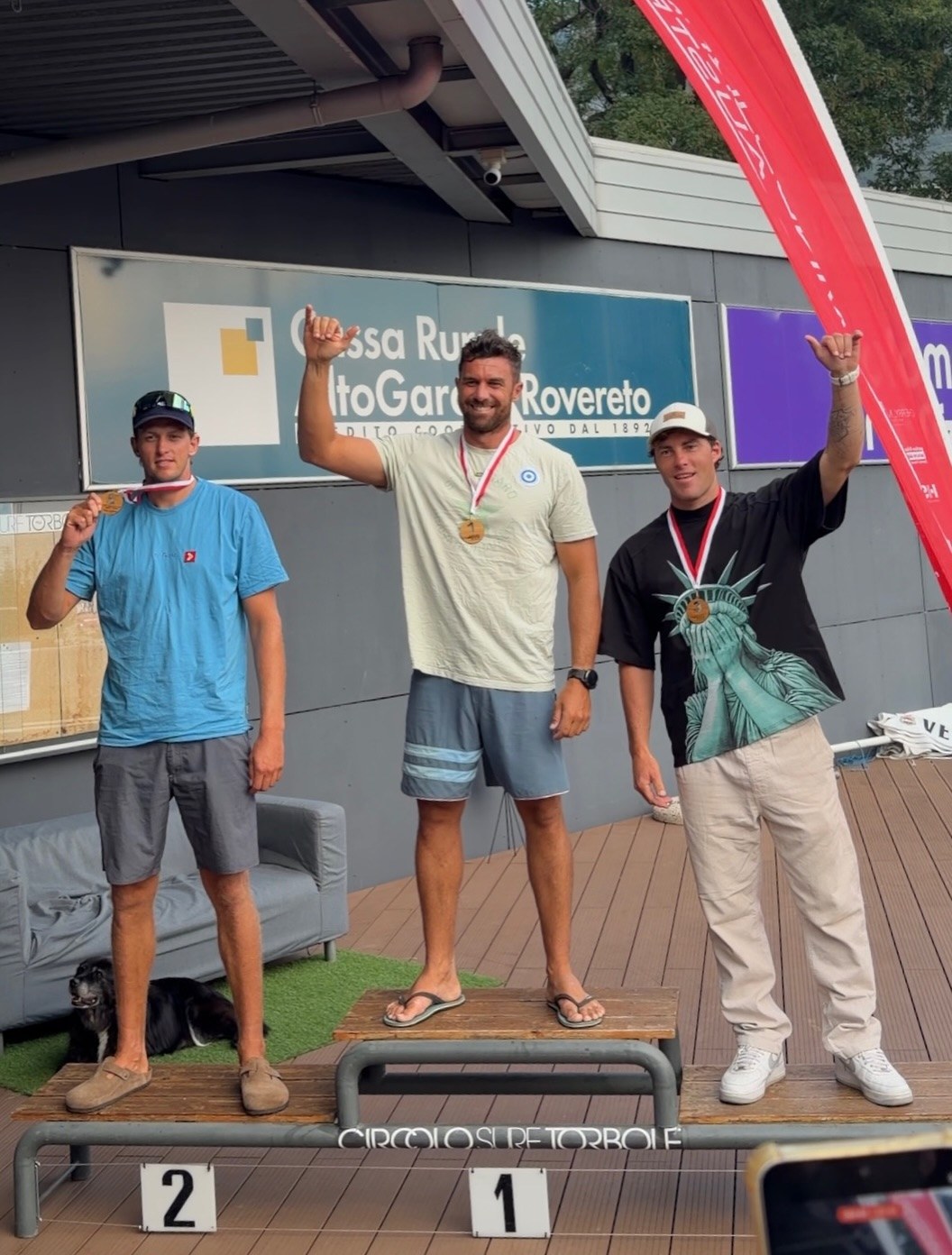 Foil podium of the Austria Slalom Cup 2026 at Circolo Surf Torbole: Matteo Iachino 1st, Fabian Wolf 2nd, Daniele Benedetti 3rd