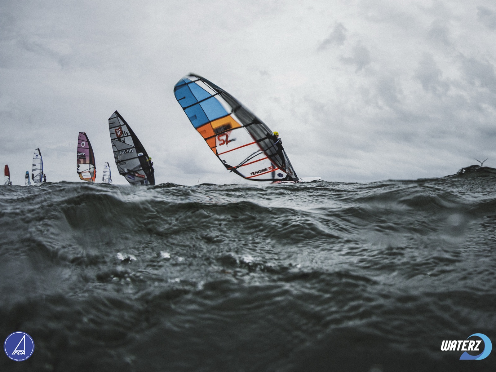 Fin slalom fleet racing in grey, choppy conditions at the 2026 IFCA Fin Slalom European Championships in Hvide Sande, Denmark